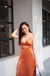 Sleeveless silk midi dress with deep V-neckline and front slit for elegant summer styling